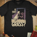 Black fantasy T-shirt with a skeleton crawling out of a dungeon doorway to touch grass and Is This Grass? text