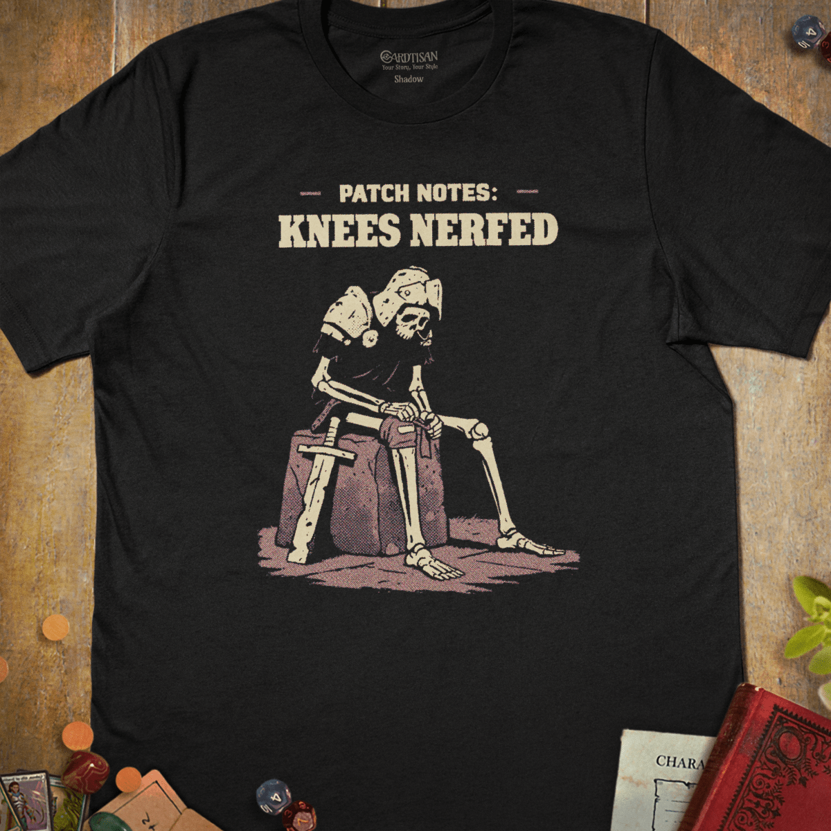 Black tabletop RPG T-shirt with a seated armored skeleton and patch notes knees nerfed text