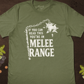 Sage green barbarian T-shirt with a spiked flail and chain illustration and If You Can Read This You’re in Melee Range text