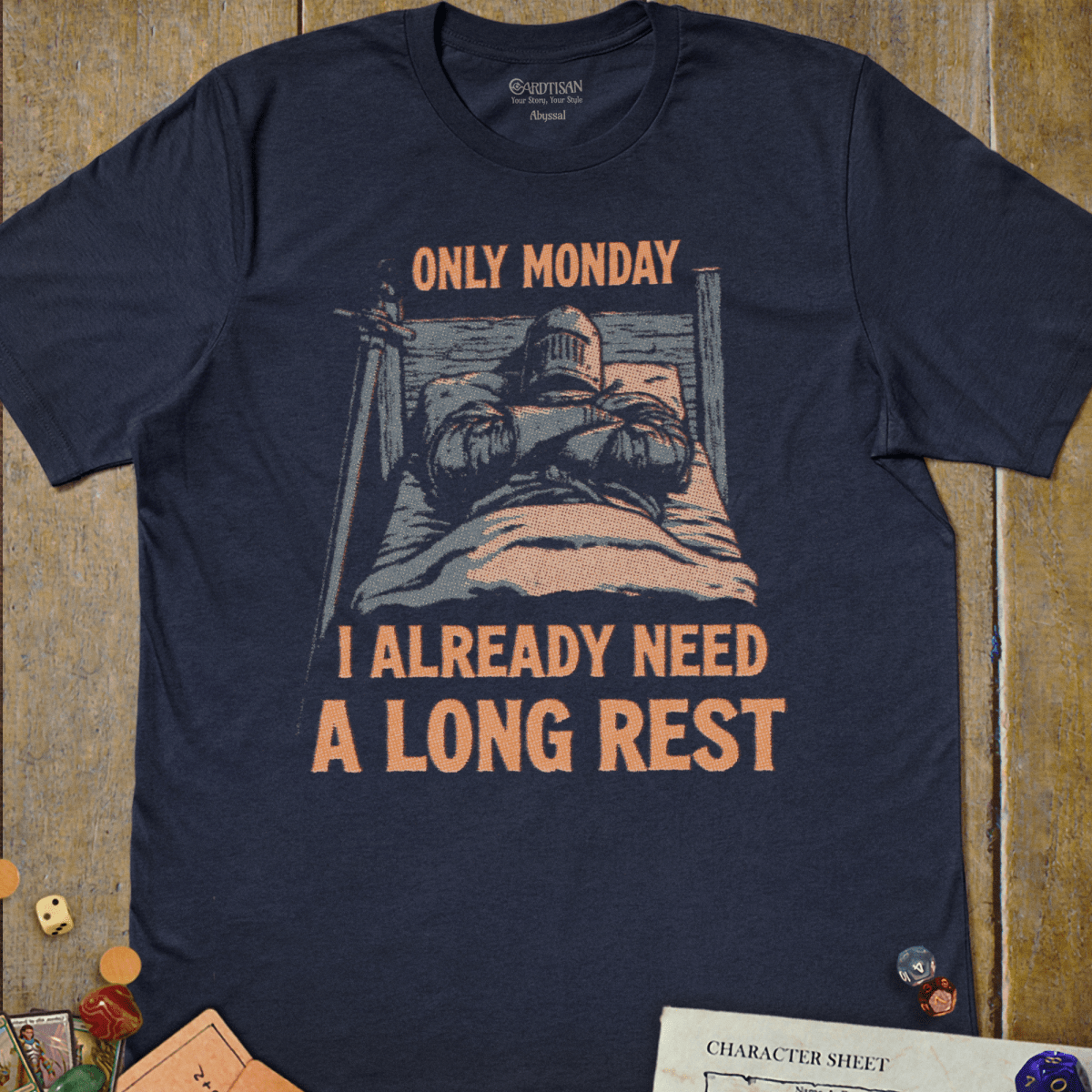 Navy graphic T-shirt with a knight tucked into bed in full armor illustration and "Only Monday, I Already Need a Long Rest" text