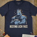 Navy graphic T-shirt with a crowned skeletal lich gently petting a sleeping cat illustration and 