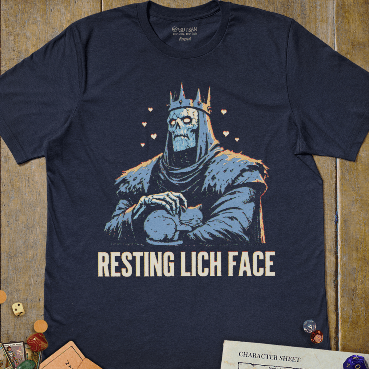 Navy graphic T-shirt with a crowned skeletal lich gently petting a sleeping cat illustration and "Resting Lich Face" text